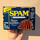 hand holding spam can